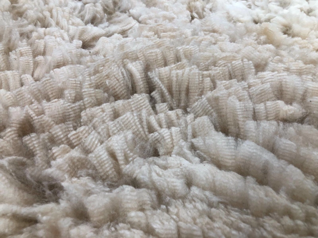 Close-up of textured white wool fabric